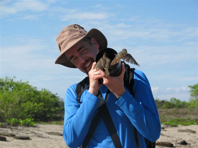 Chris Earley with Galapagos flycatchers, photo by Tom Chatterton